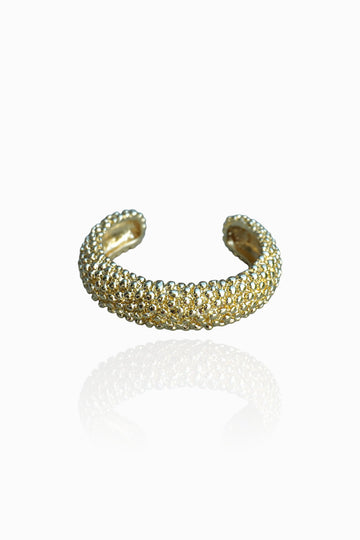 Massive metal bracelet with grainy texture